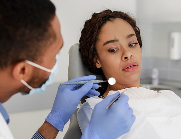 Woman afraid in the dental chair